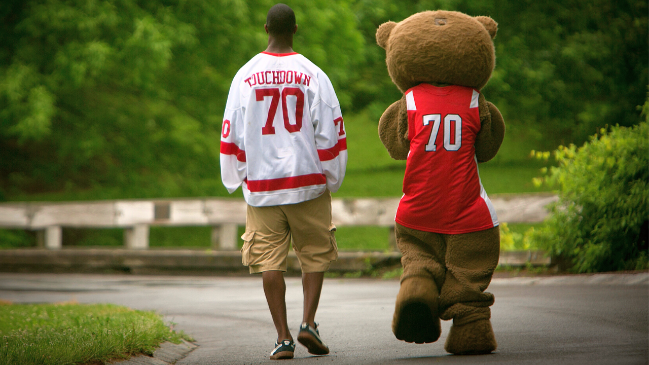 Student walking with Touchdown mascot
