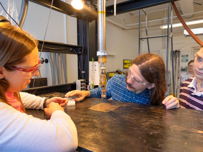 Postdoctoral researcher Christopher Petroff (center), doctoral candidate Virginia McGhee (left), doctoral student Azriel Finsterer (right) and Lara Estroff, the Herbert Fisk Johnson Professor of Industrial Chemistry in Cornell Engineering (background), work on perovskites – a class of compound minerals that over the last decade have become the most exciting alternative to silicon.