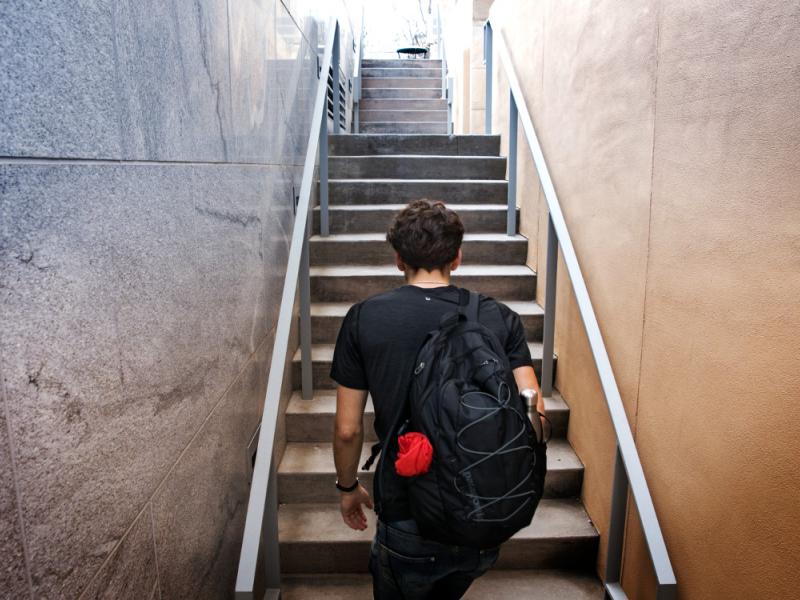 A student climbs the stairs outside Klarman Hall.