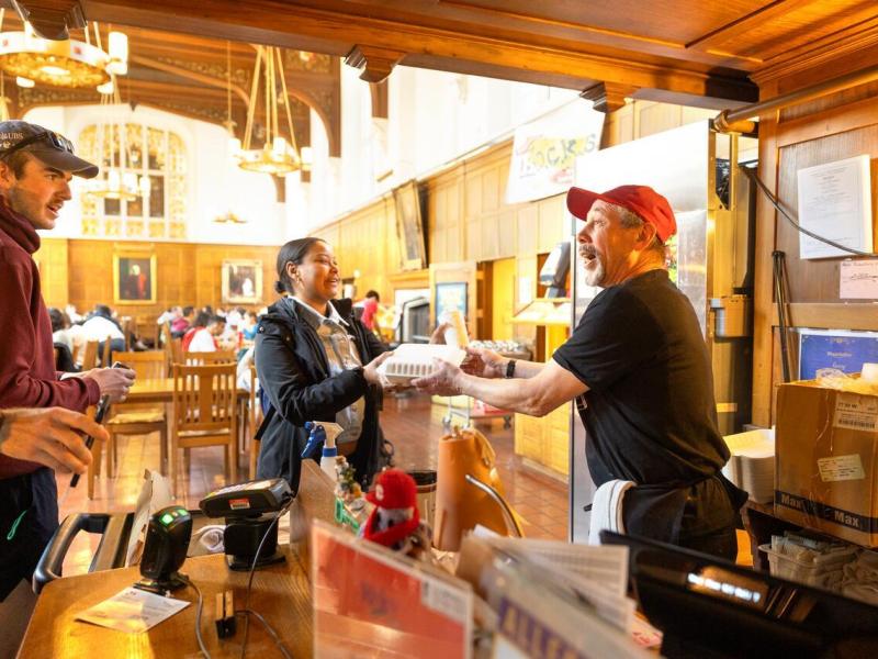 Garry Gale, door checker at Risley Dining Hall, chats with members of the campus community as he rings their lunches up at lunch time.